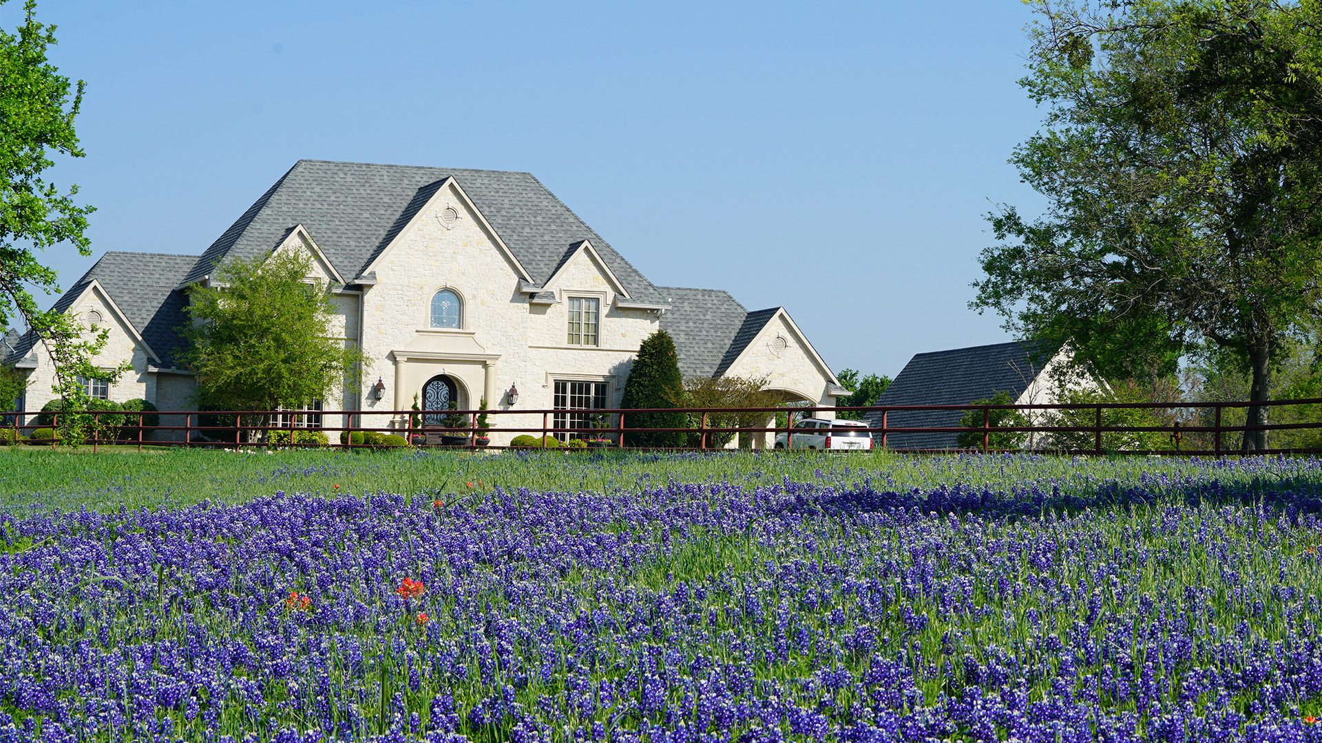 Home with lights on during an outage, protected by a HomeSafe standby generator